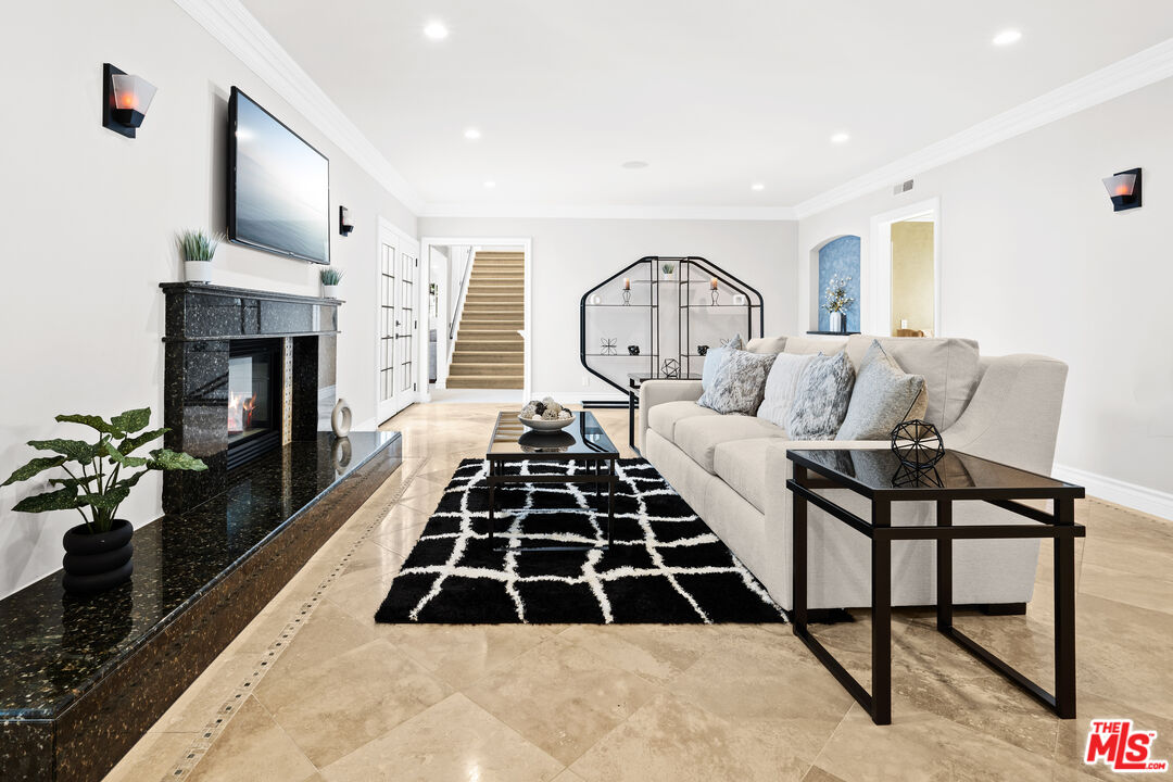 2563 Hutton Drive Beverly Hills, CA 90210 - Photo 21 of 69 a living room with a couch a fireplace and a potted plant