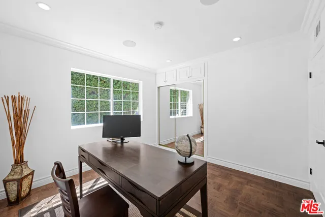 a bedroom with two beds and a large window