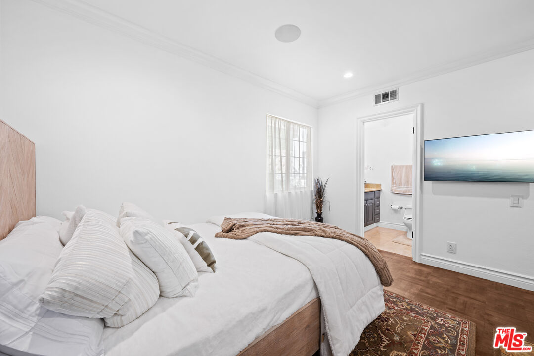 2563 Hutton Drive Beverly Hills, CA 90210 - Photo 28 of 69 a bedroom with a bed and a flat screen tv