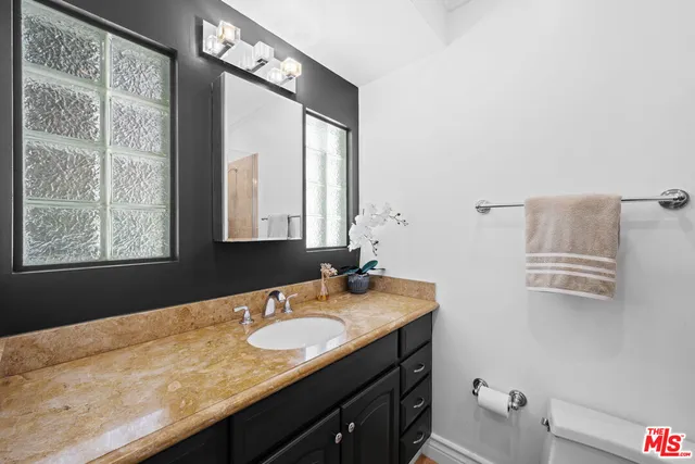 a bathroom with a tub a sink and a large mirror