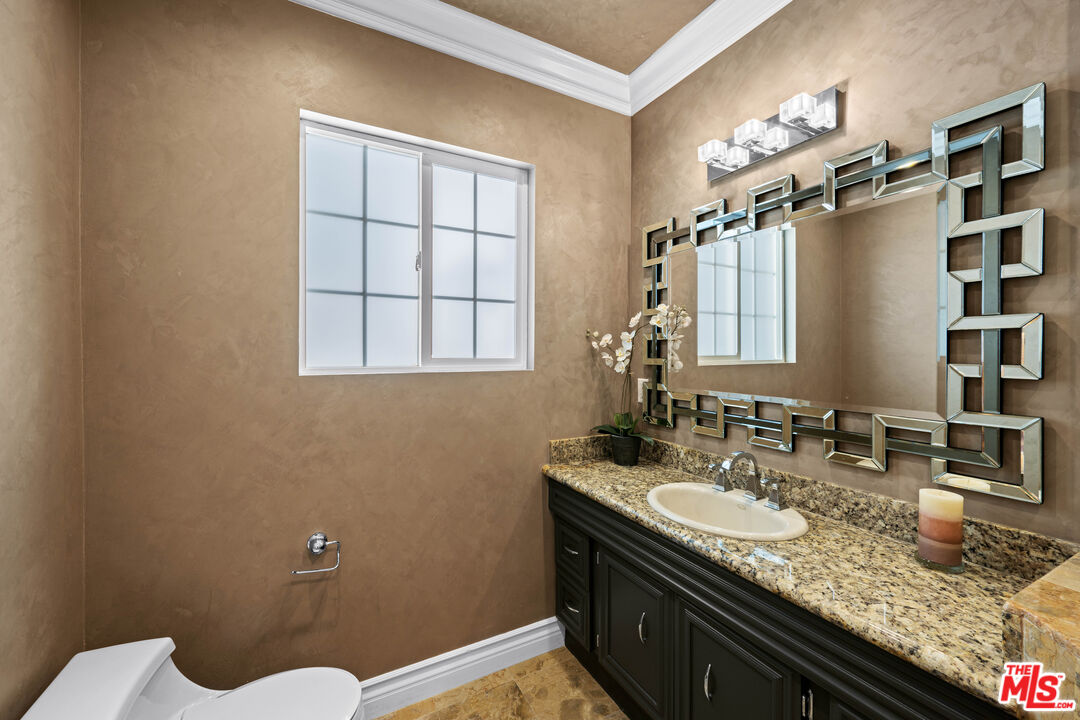 2563 Hutton Drive Beverly Hills, CA 90210 - Photo 33 of 69 a bathroom with a granite countertop sink a toilet and shower
