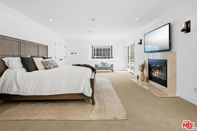 a spacious bedroom with a bed a couch and dresser