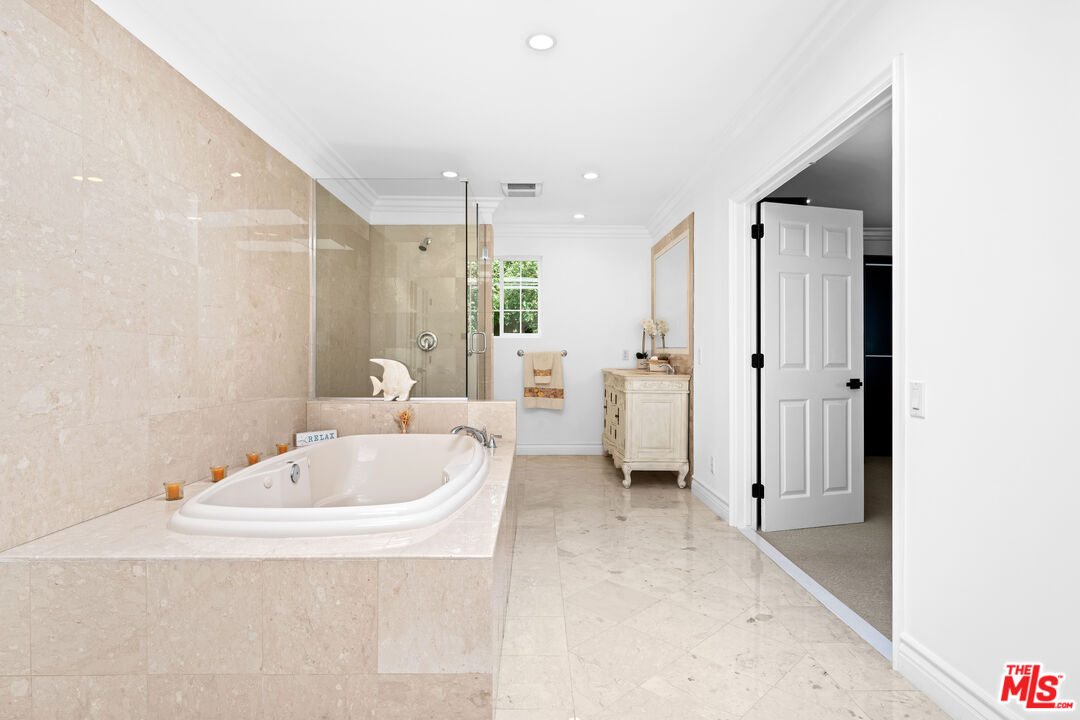 2563 Hutton Drive Beverly Hills, CA 90210 - Photo 38 of 69 a bathroom with a tub a sink and a large mirror