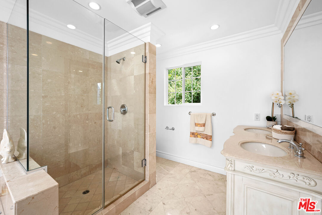 2563 Hutton Drive Beverly Hills, CA 90210 - Photo 39 of 69 a bathroom with a granite countertop sink a shower and a mirror