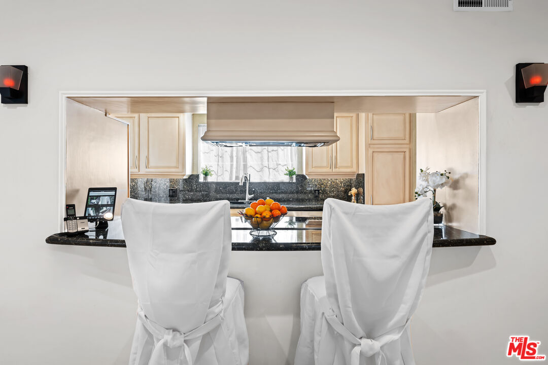 2563 Hutton Drive Beverly Hills, CA 90210 - Photo 4 of 69 a living room with furniture a large window and gym equipment