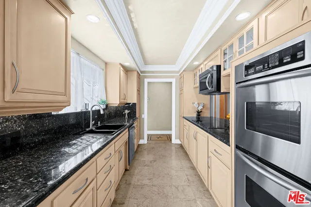 a kitchen with stainless steel appliances granite countertop a stove and a sink