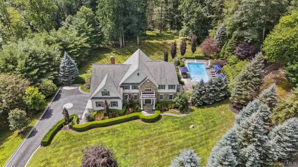 an aerial view of a house with a big yard and potted plants