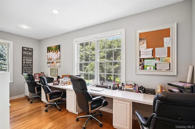 a view of a workspace with furniture and a window