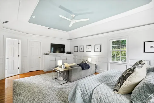 a bed room with a bed furniture and a flat screen tv