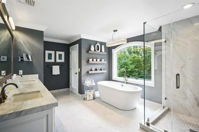 a bathroom with a tub sink and mirror