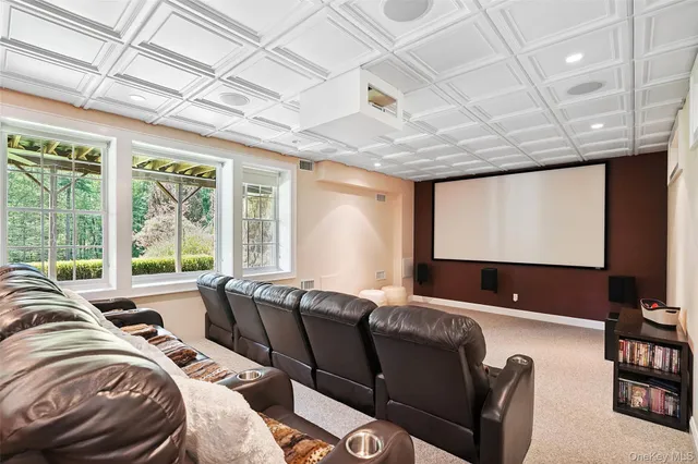 a living room with furniture a projector and a large window