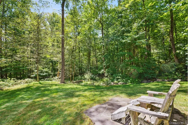 a view of yard with swimming pool and green space