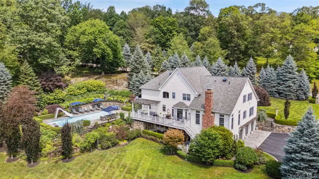 an aerial view of a house with a yard basket ball court and outdoor seating