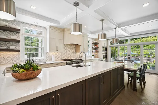 a kitchen with a sink a counter and appliances