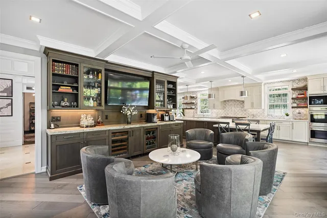 a living room with furniture a large window and potted plant