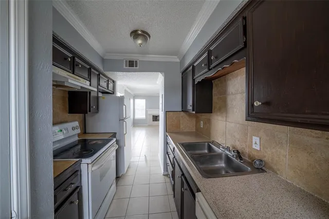 a kitchen with granite countertop a sink and stainless steel appliances