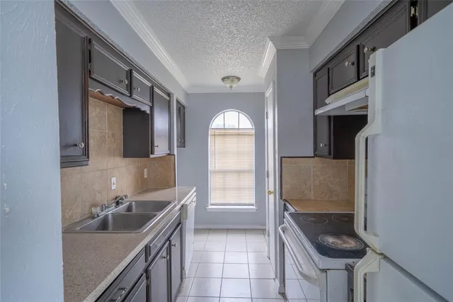 a kitchen with a sink cabinets and stove