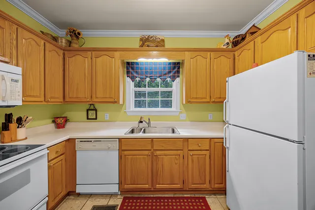 a kitchen with a refrigerator a sink and cabinets