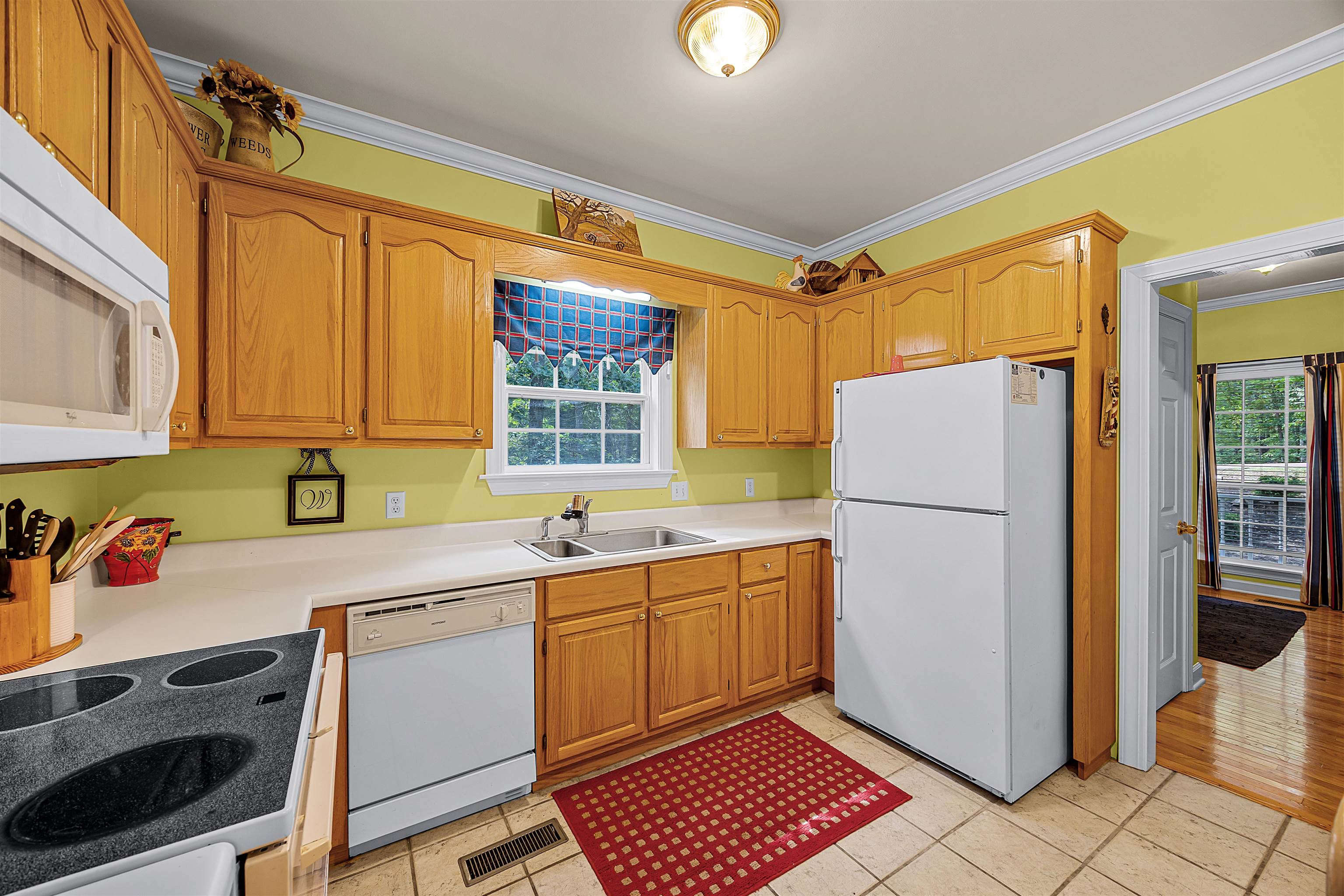 405 Anderson Hollow Road Savannah, TN 38372 - Photo 13 of 34 a kitchen with a sink a refrigerator and cabinets
