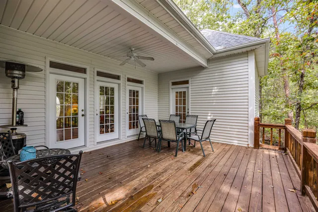 a view of a patio with table and chairs and wooden floor