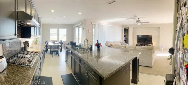 a view of a dining room and livingroom with furniture wooden floor a chandelier