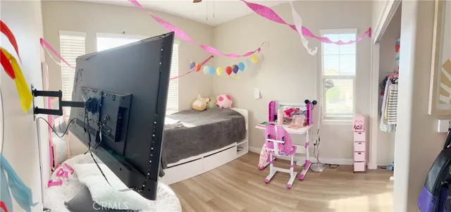 a bedroom with furniture and a window