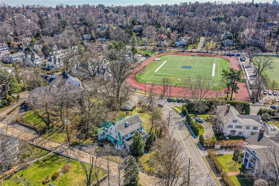 an aerial view of residential houses with outdoor space and swimming pool