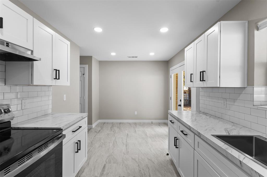 1903 Beauford Road Dallas, TX 75253 - Photo 9 of 27 White shaker cabinetry with black hardware, subway tile backsplash, light-toned countertop, stainless steel sink, and recessed lighting