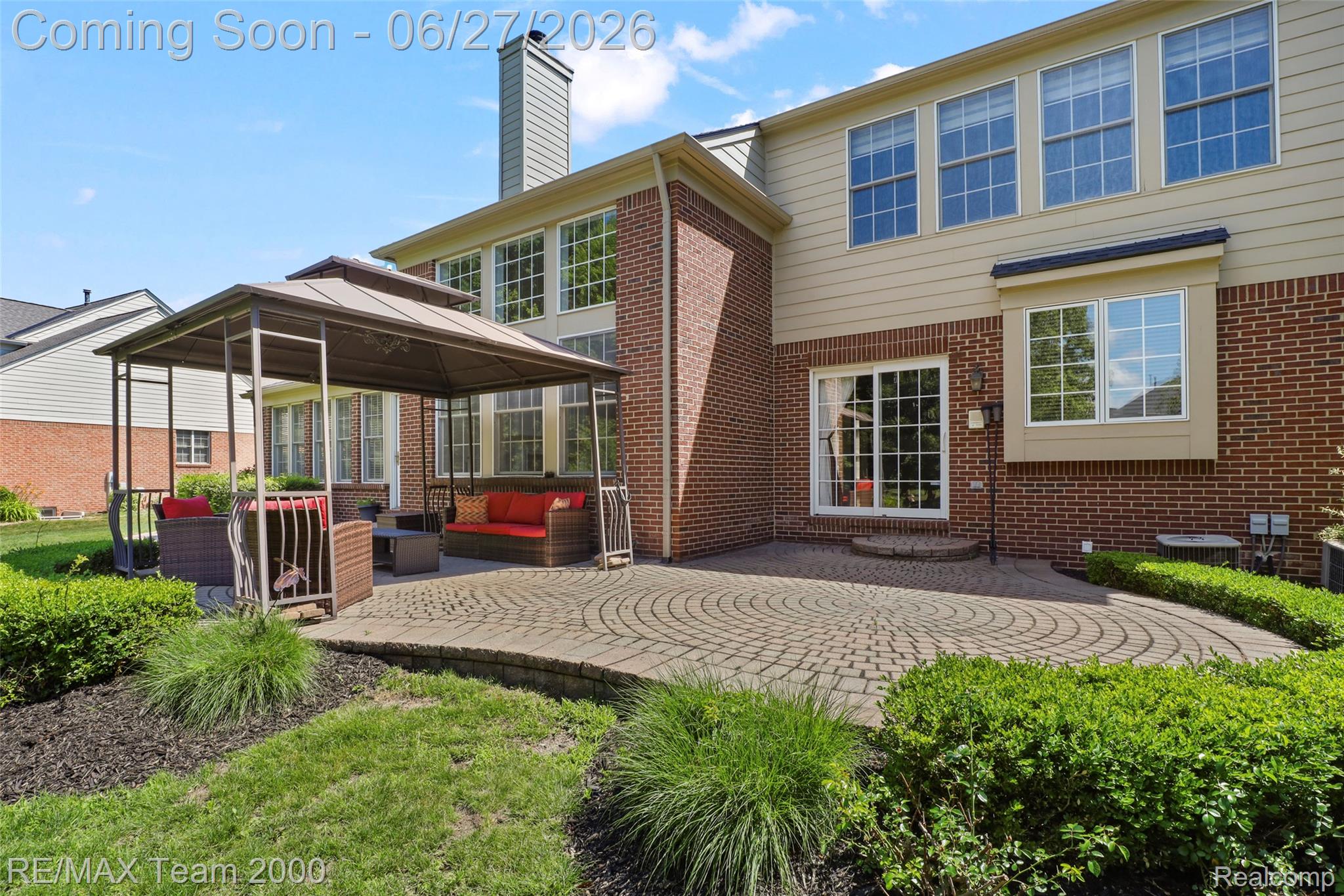 1248 Lasalle Road Canton, MI 48187 - Photo 15 of 67 Expansive brick and siding exterior featuring a circular paver patio with a built-in fire pit area and a gazebo
