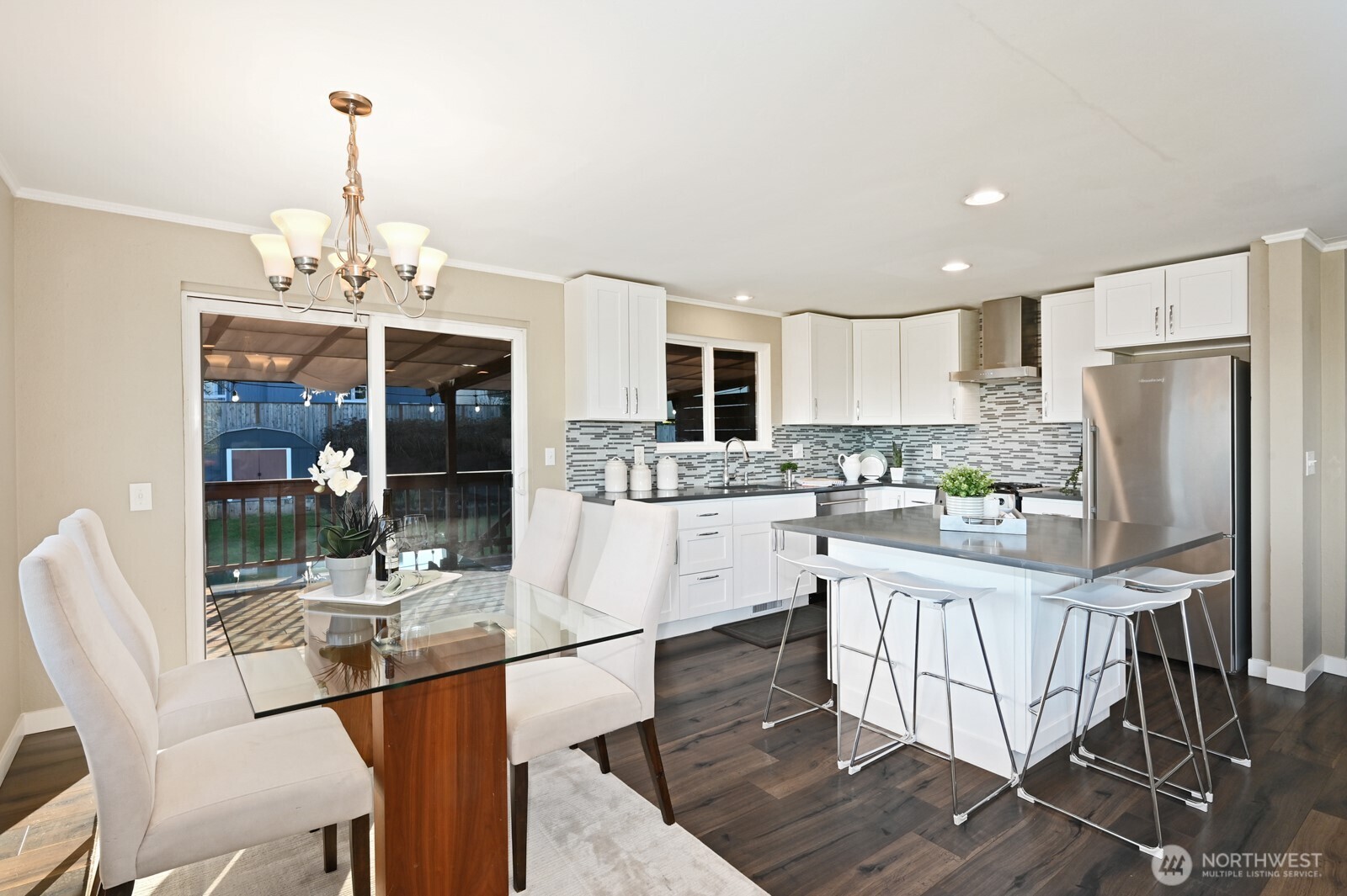 2525 South Raymond Street Seattle, WA 98108 - Photo 11 of 38 a kitchen with stainless steel appliances kitchen island granite countertop a table chairs and a refrigerator