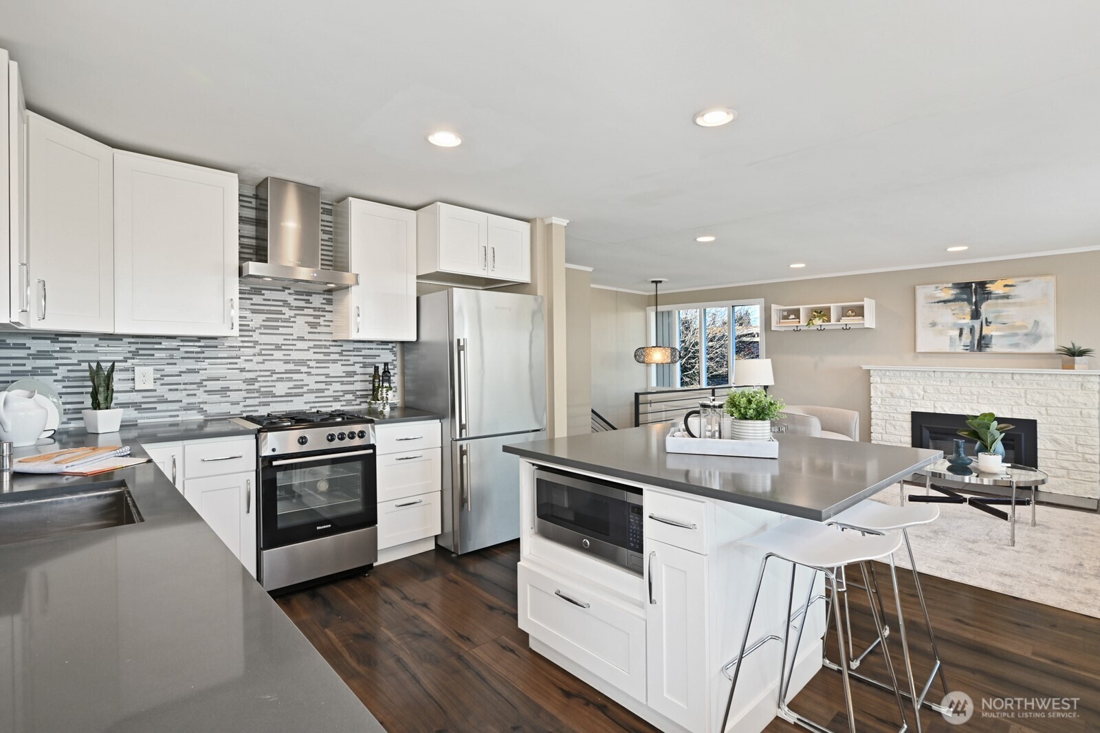 2525 South Raymond Street Seattle, WA 98108 - Photo 12 of 38 a kitchen with white cabinets and stainless steel appliances