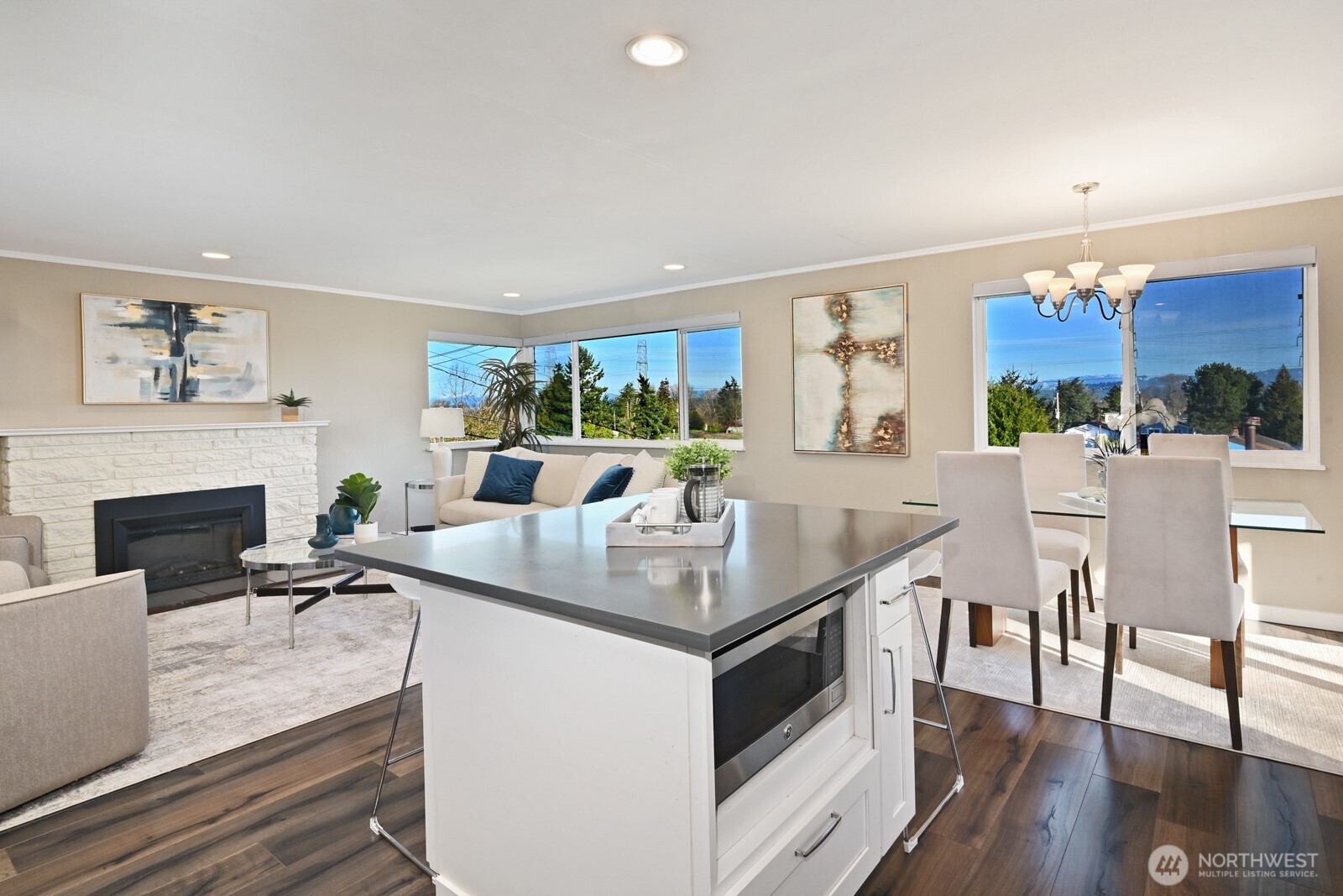 2525 South Raymond Street Seattle, WA 98108 - Photo 13 of 38 a kitchen with granite countertop a table chairs stove and wooden floor