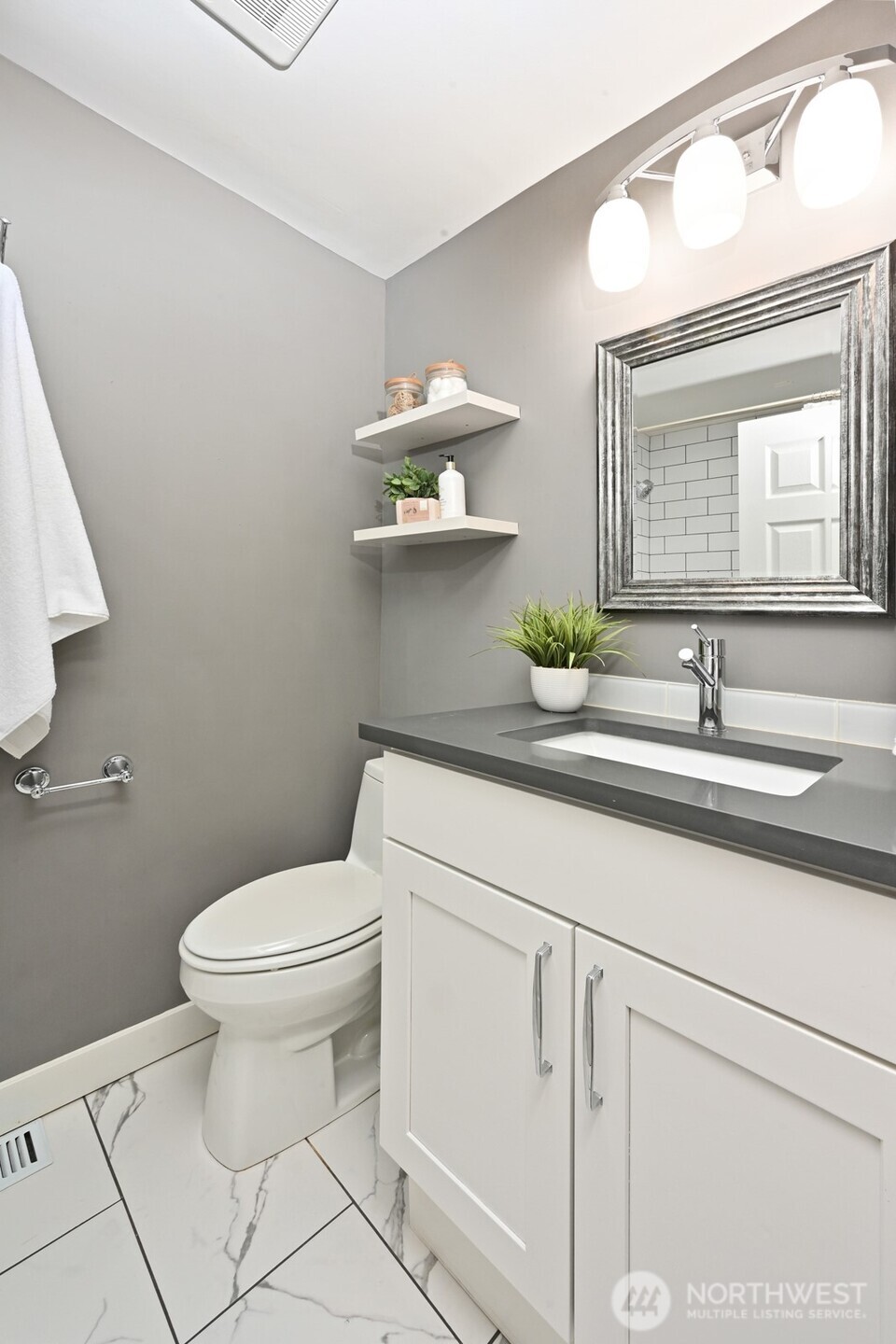 2525 South Raymond Street Seattle, WA 98108 - Photo 21 of 38 a bathroom with a sink a toilet and mirror