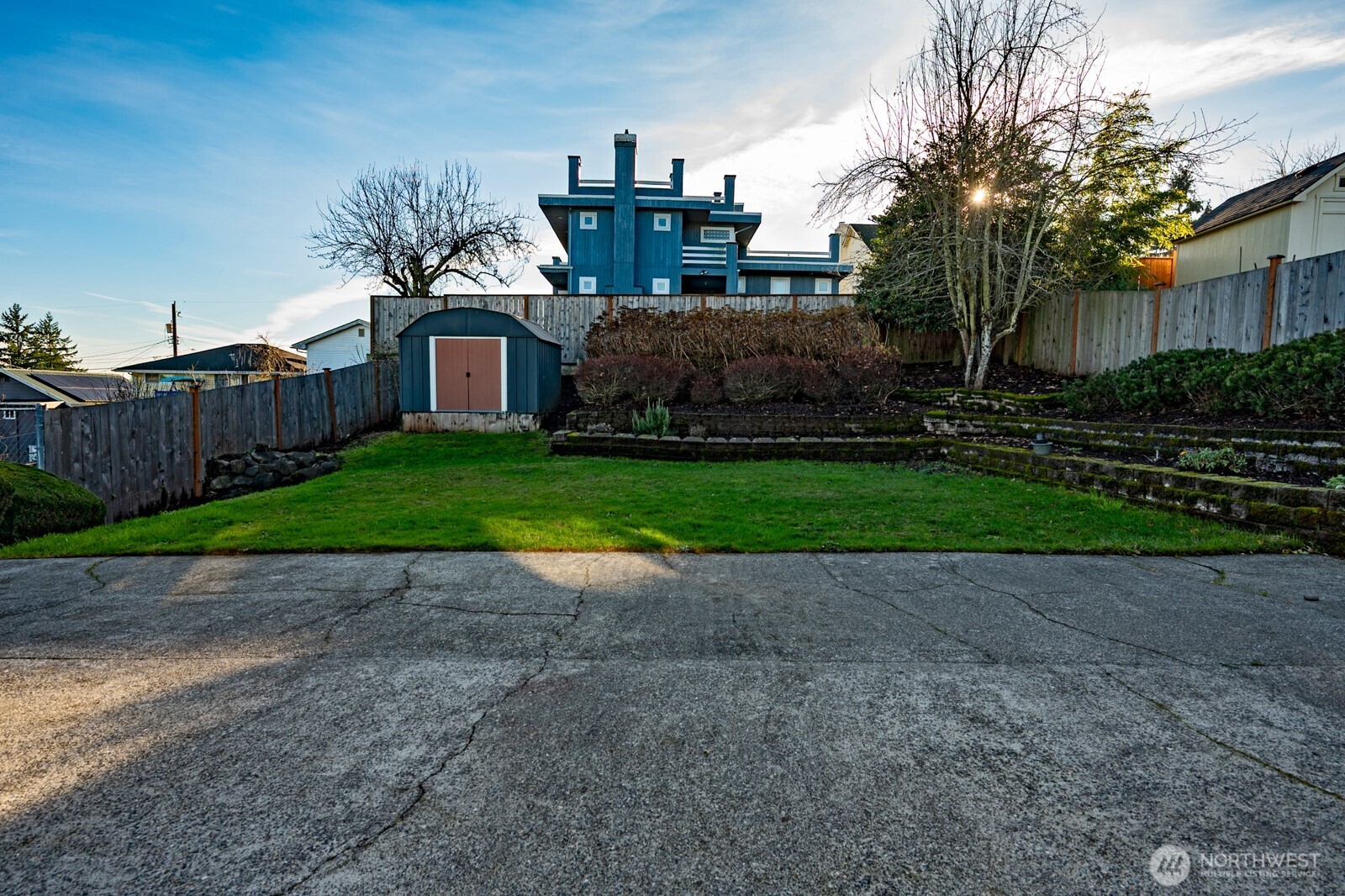 2525 South Raymond Street Seattle, WA 98108 - Photo 36 of 38 a view of a back yard with flower plants and wooden fence