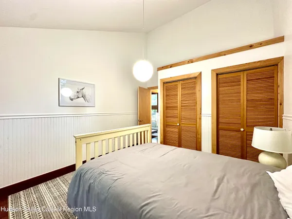 a bedroom with two beds and a potted plant