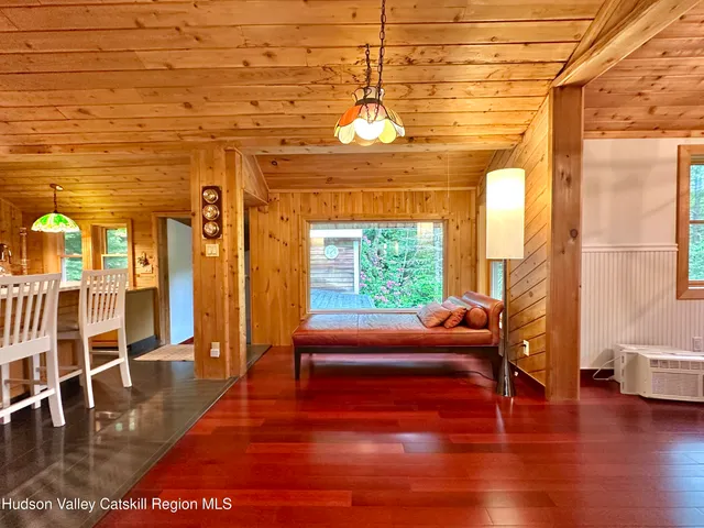 a living room with a flat screen tv and a large window with outer view