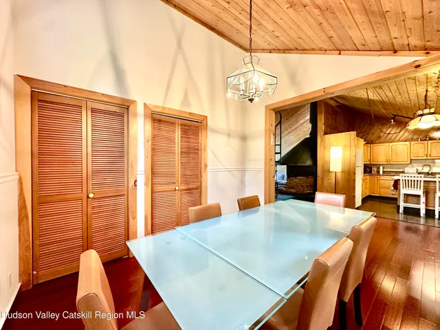 a living room with stainless steel appliances kitchen island granite countertop furniture and a flat screen tv