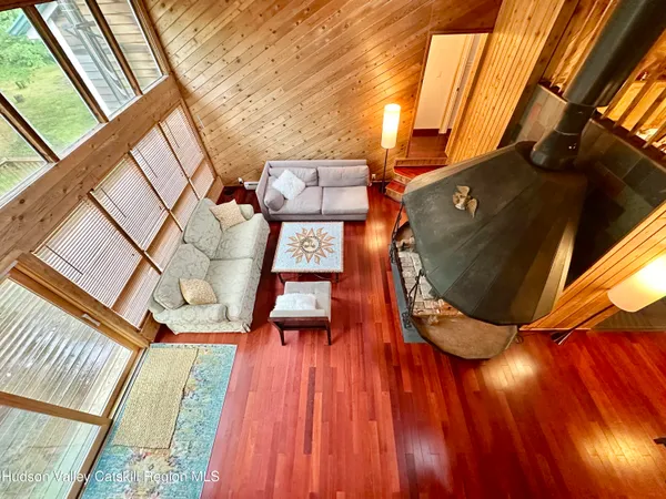 a kitchen with stainless steel appliances a stove top oven a sink dishwasher and a refrigerator with wooden floor