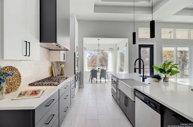a kitchen with granite countertop a stove and a microwave