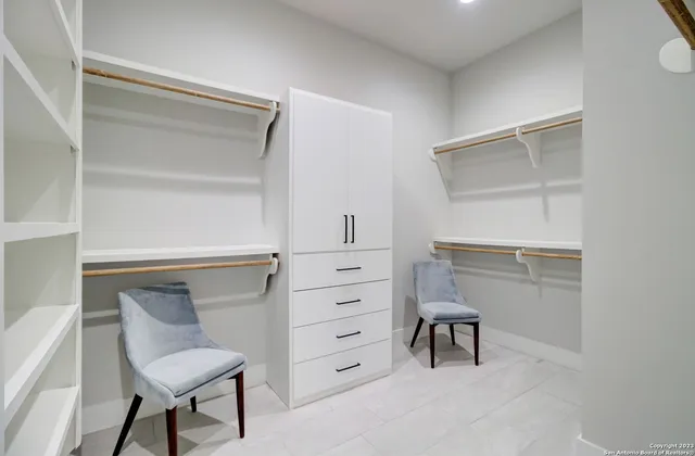 a spacious bathroom with a tub sink and mirror