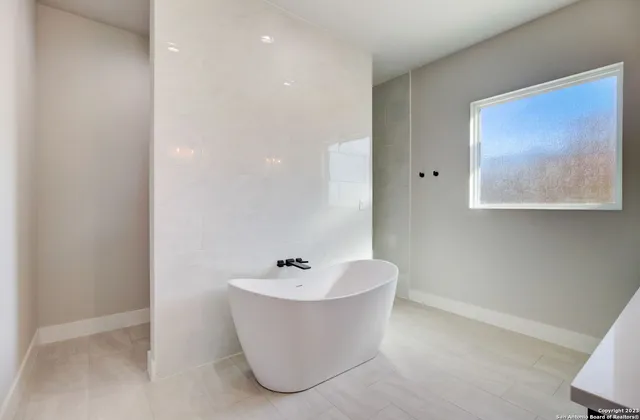a spacious bathroom with a double vanity sink and mirror