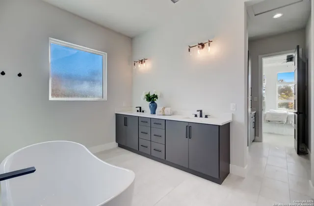 a living room with furniture and a wall painting