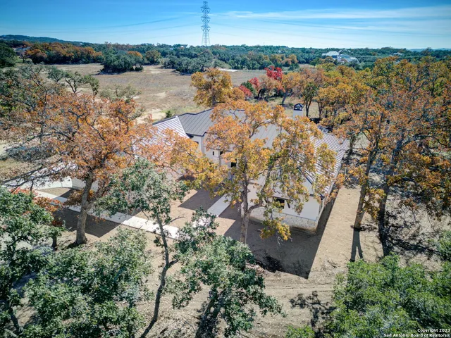an aerial view of a house with a yard