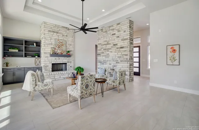 a living room with furniture a fireplace and a flat screen tv