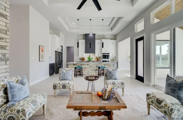 a living room with furniture and a chandelier