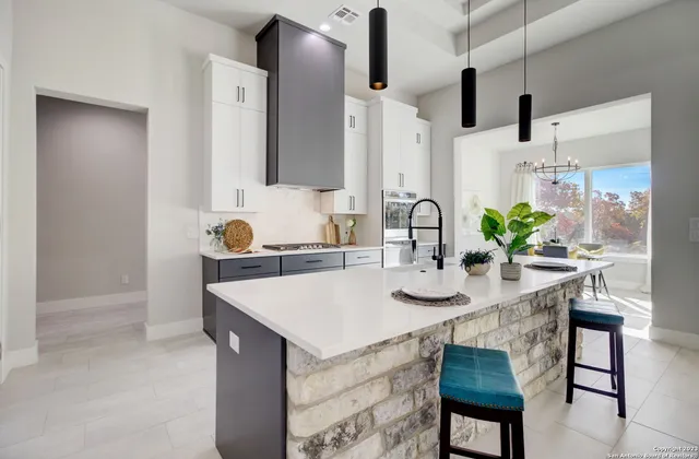 a kitchen with a table and chairs in it