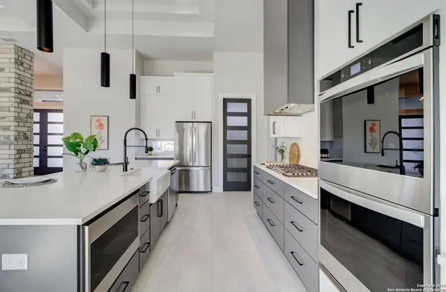 a kitchen with counter top space stainless steel appliances and cabinets