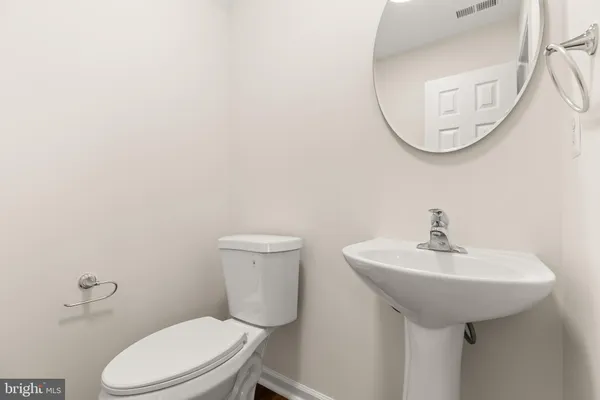 a bathroom with a sink a mirror and a toilet