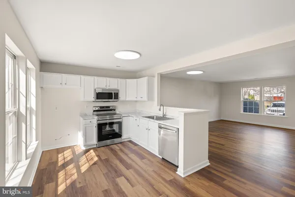 a kitchen with a stove and a refrigerator