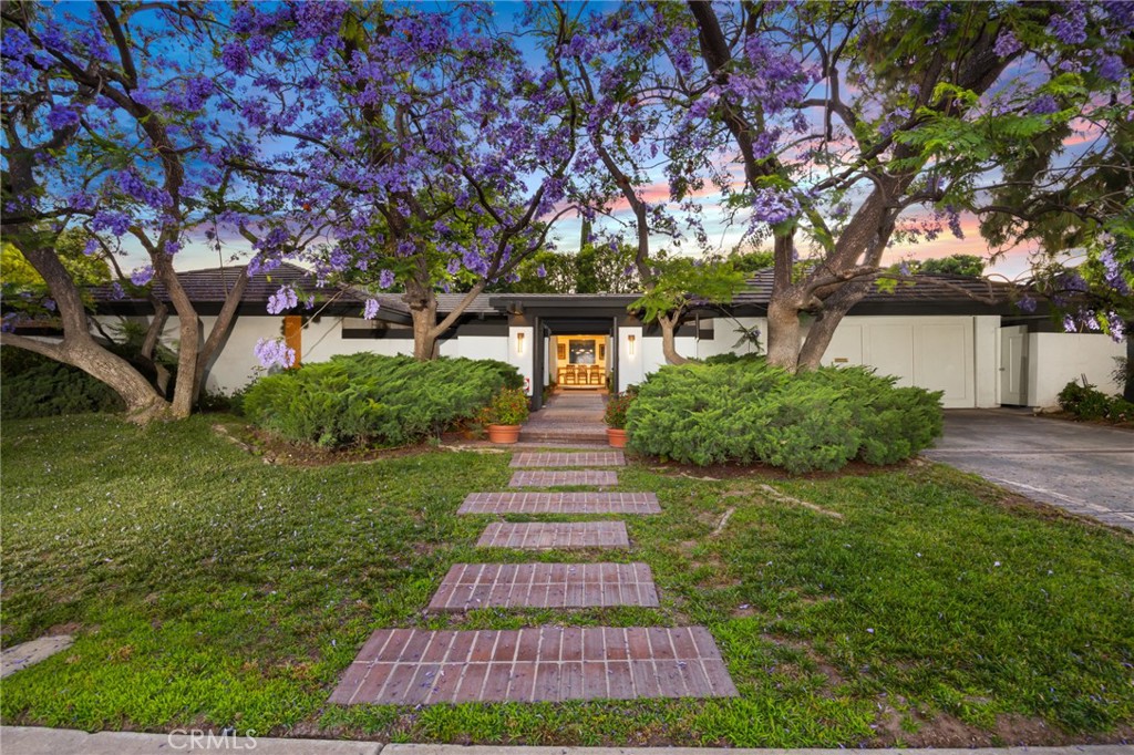 a front view of a house with garden